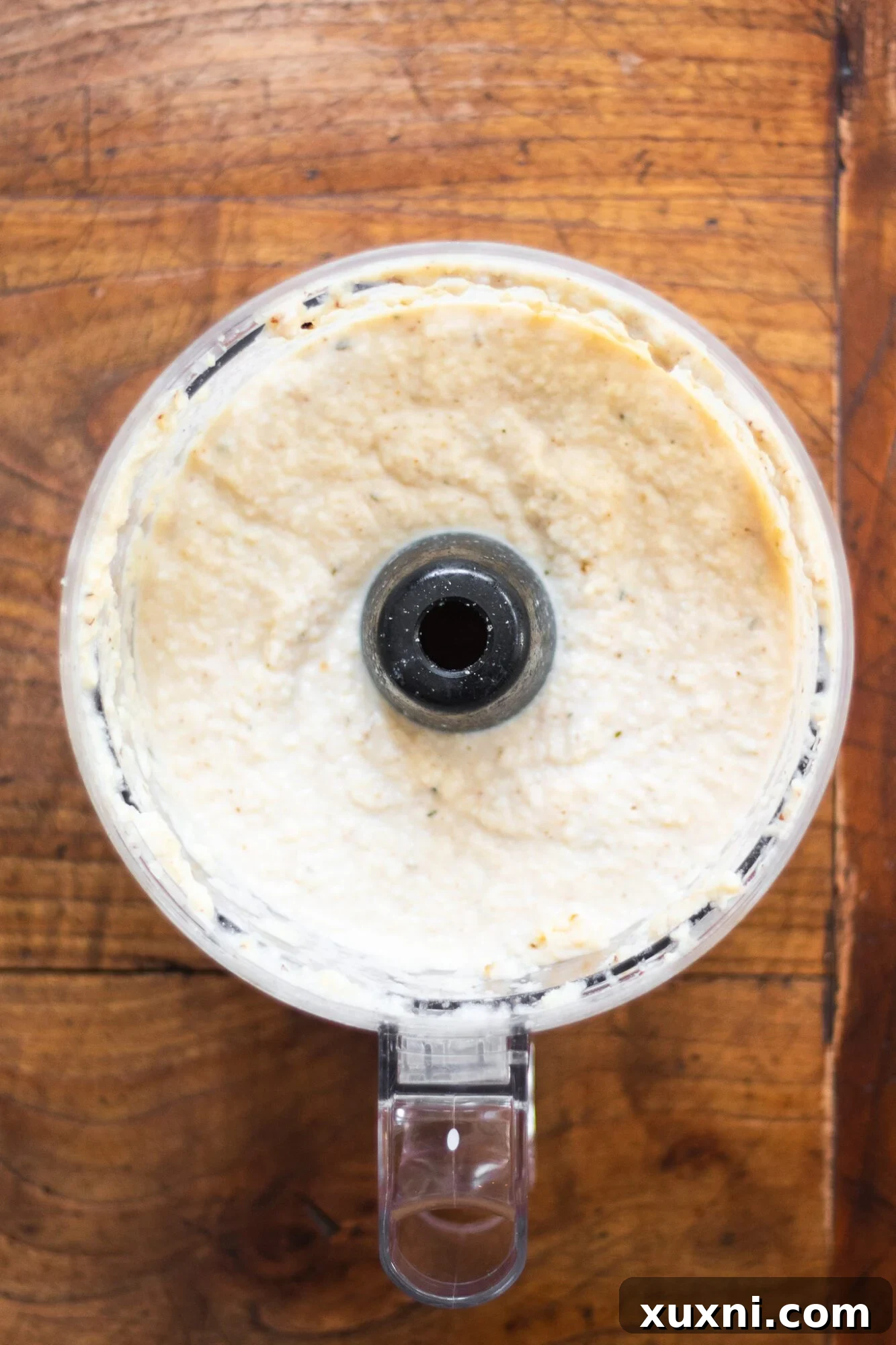 Guilt-Free Fettuccine Alfredo 6 Close-up of freshly blended cauliflower Alfredo sauce in a blender, showing its smooth and creamy texture, ready to be served.