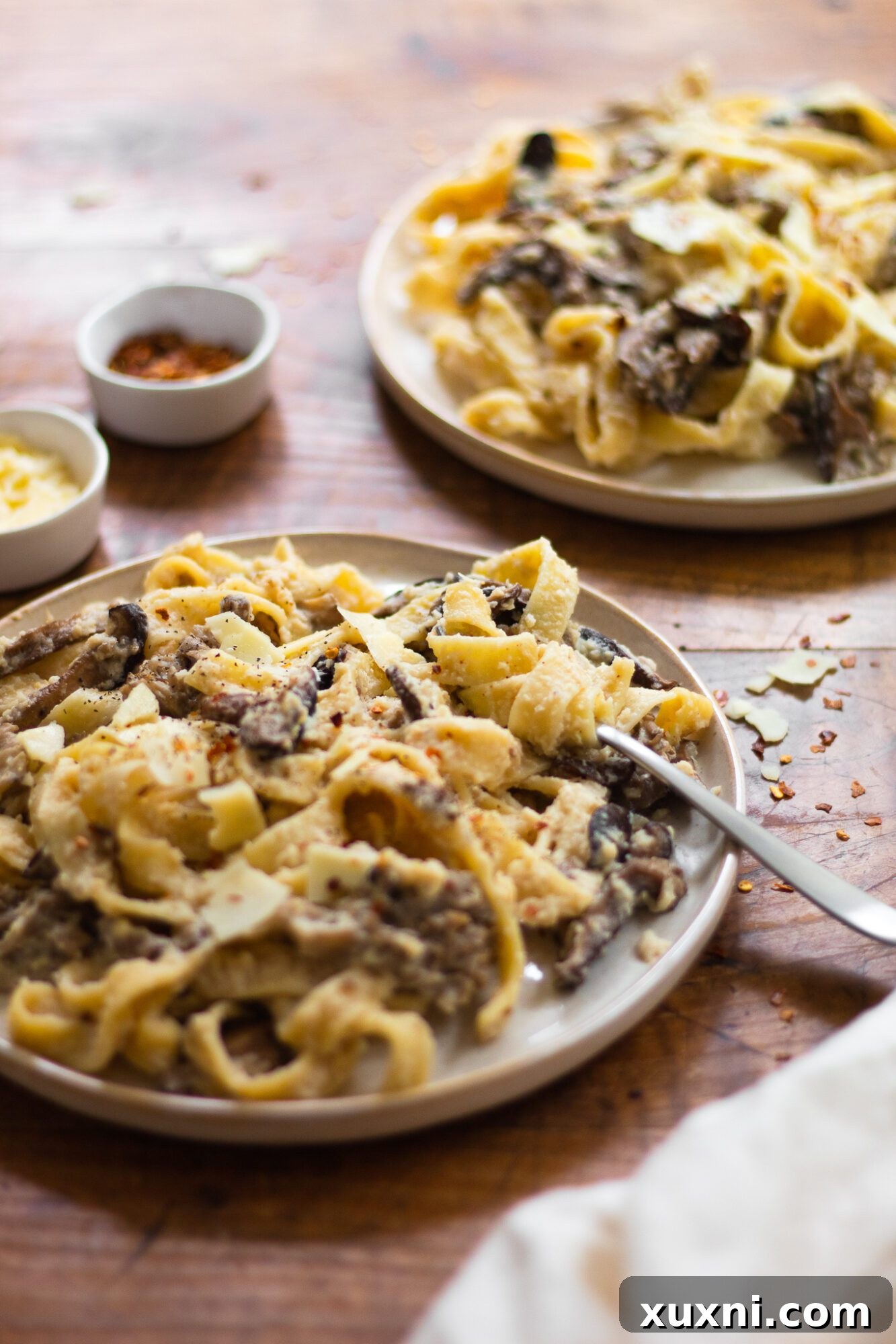 Guilt-Free Fettuccine Alfredo 9 A close-up shot of swirled fettuccine Alfredo pasta, showing the rich, creamy sauce coating each noodle, ready to be enjoyed.
