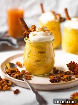 Healthy oatmeal jars with whipped cream and granola sprinkled around them, a perfect breakfast