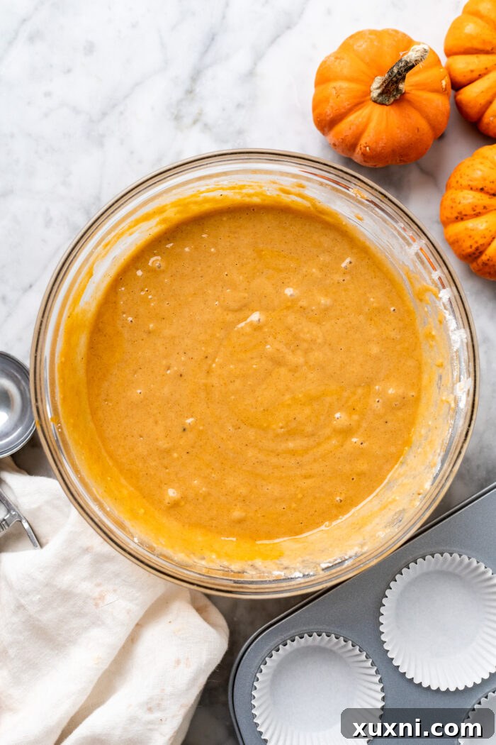 Smooth vegan pumpkin cupcake batter in a mixing bowl.