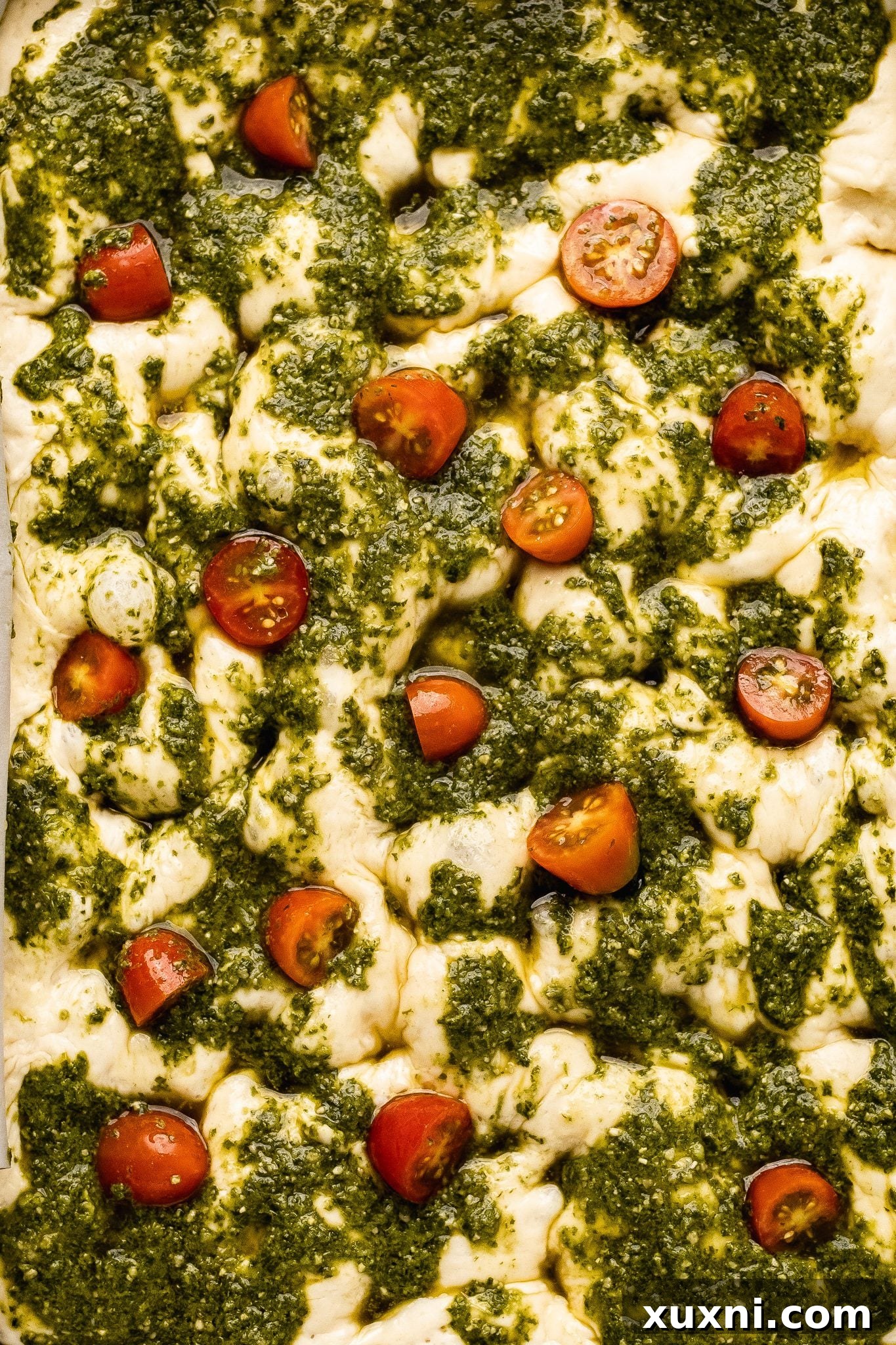 pesto focaccia dough with cherry tomatoes