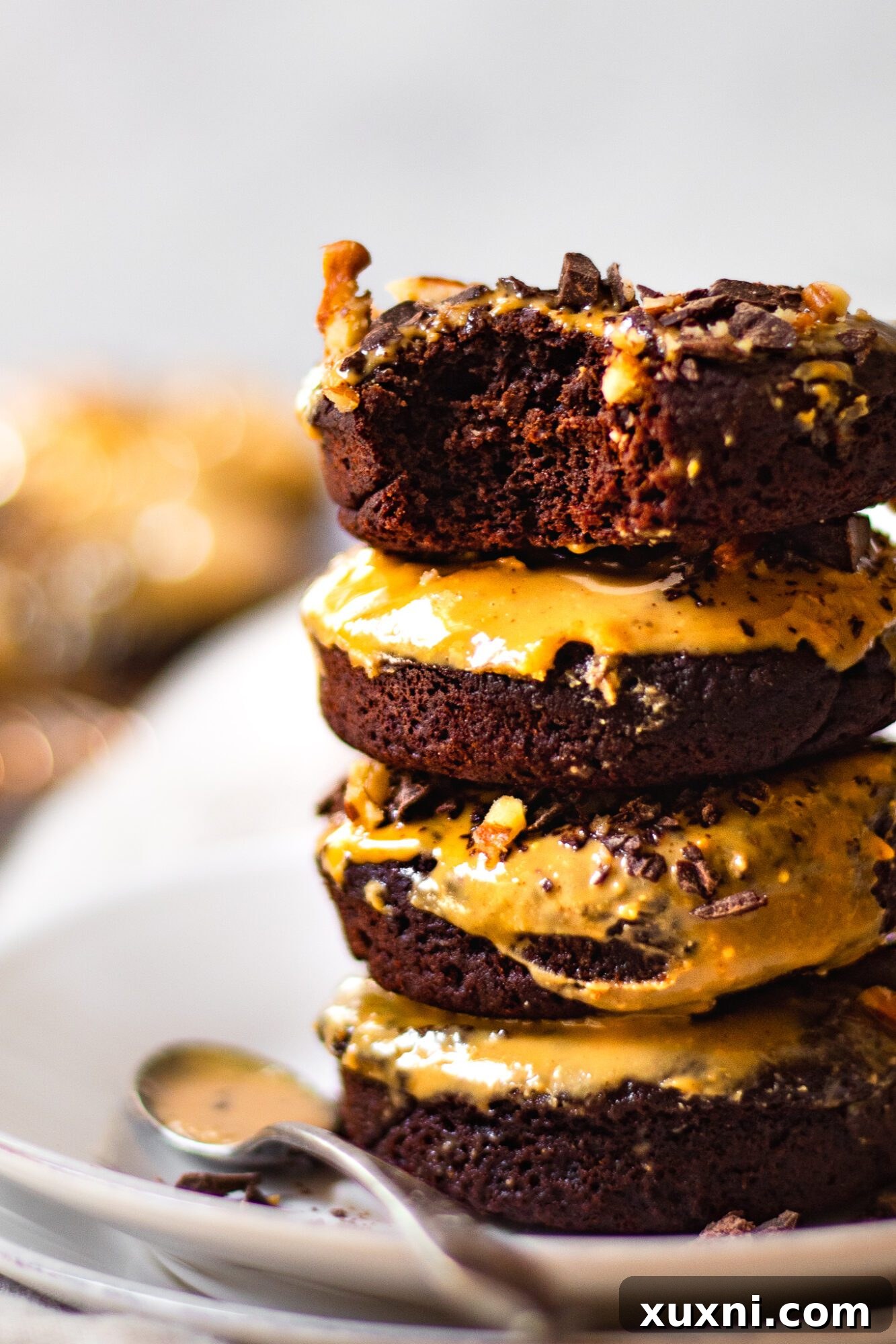 Stacked gluten-free donuts with a generous peanut butter glaze