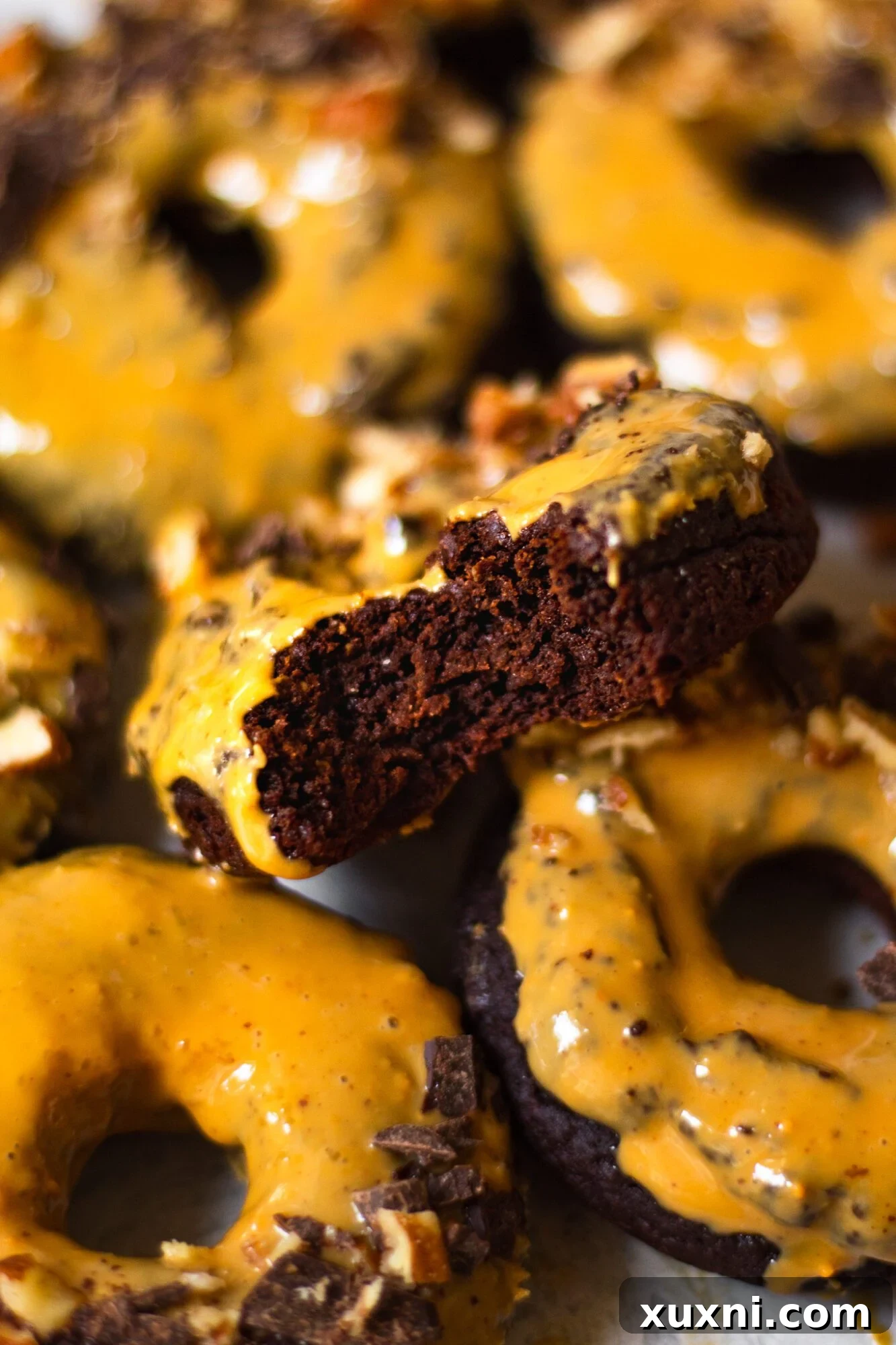 Close-up of a bite taken from a baked chocolate donut