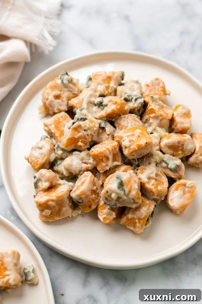 Plate of vegan sweet potato gnocchi in garlic sage sauce