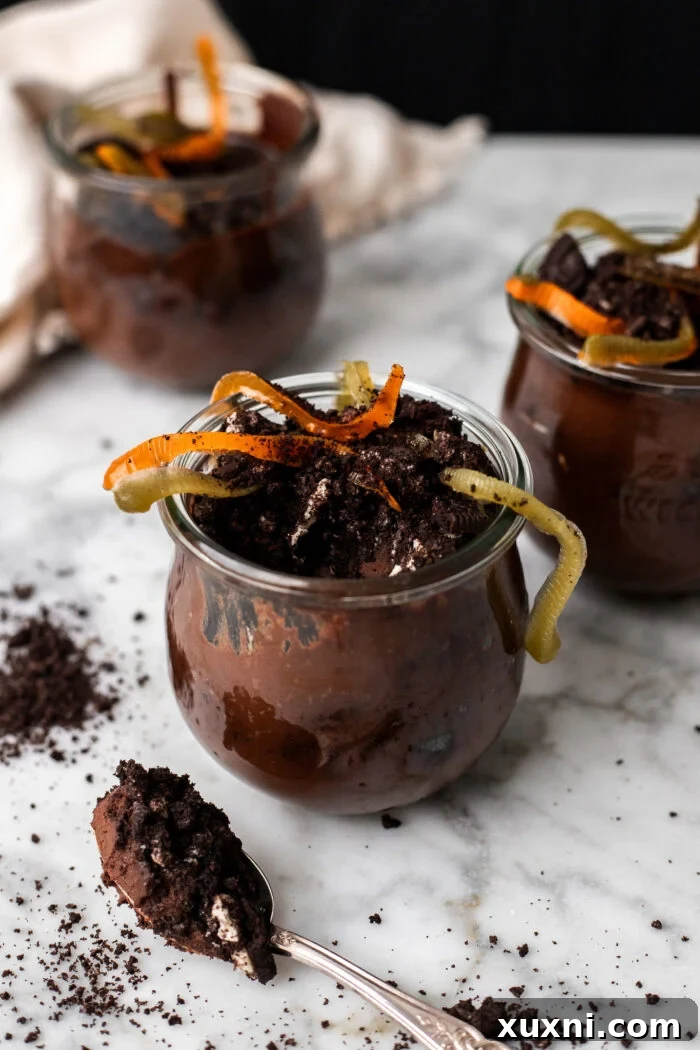 Finished vegan dirt pudding cups arranged on a table, ready to be served.