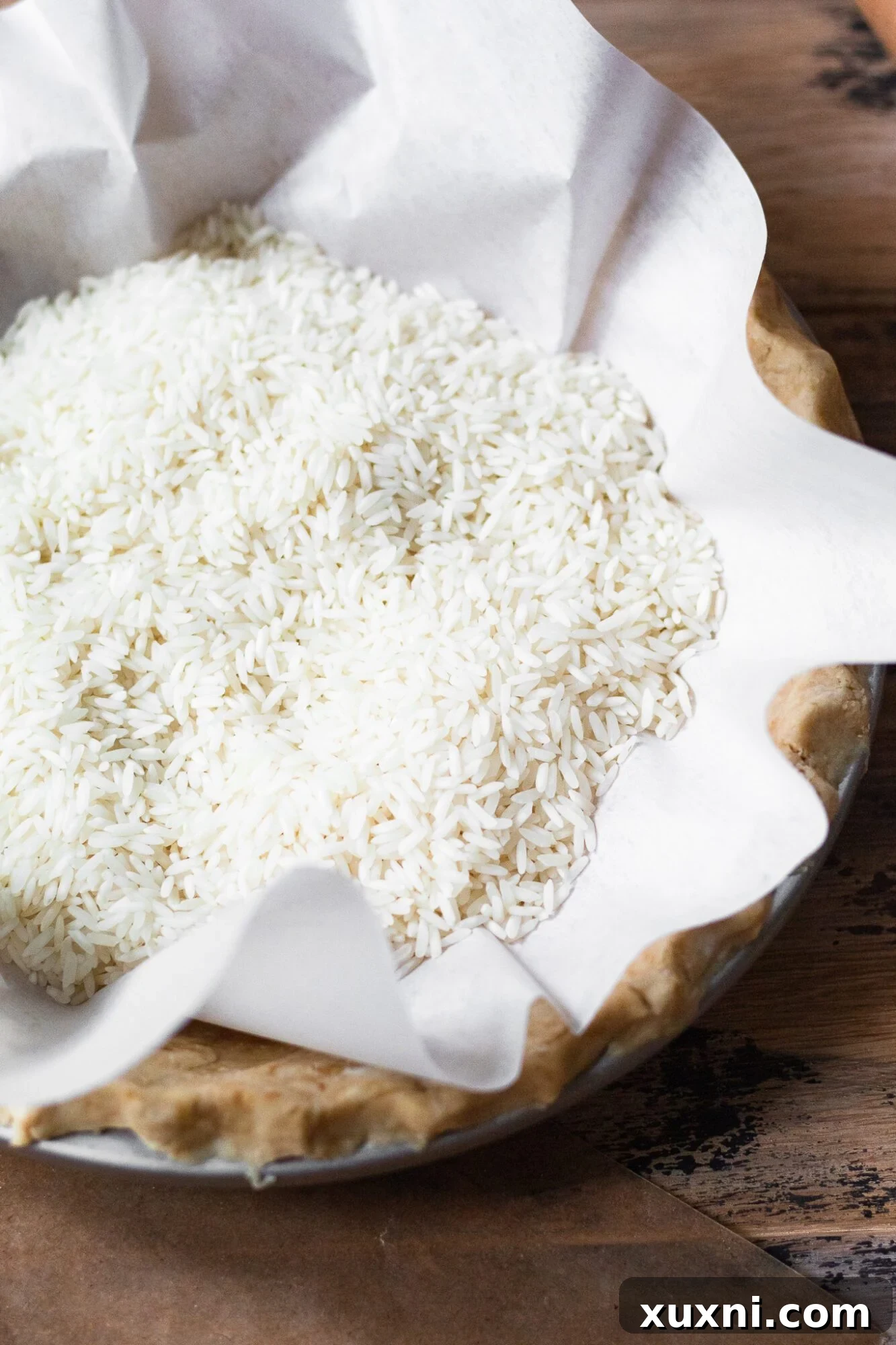 Easy Flaky Vegan Pie Crust The All-Vegan Butter Method 12 Rice used as pie weights in a pie crust for blind baking.