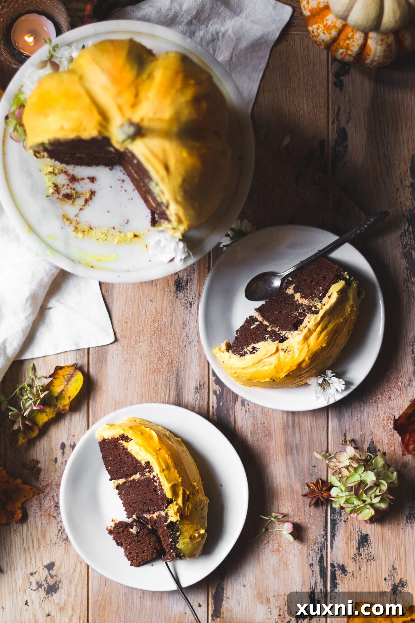 Several slices of the gluten-free vegan pumpkin cake, showing off its moist texture and perfect layers with creamy pumpkin spice frosting.