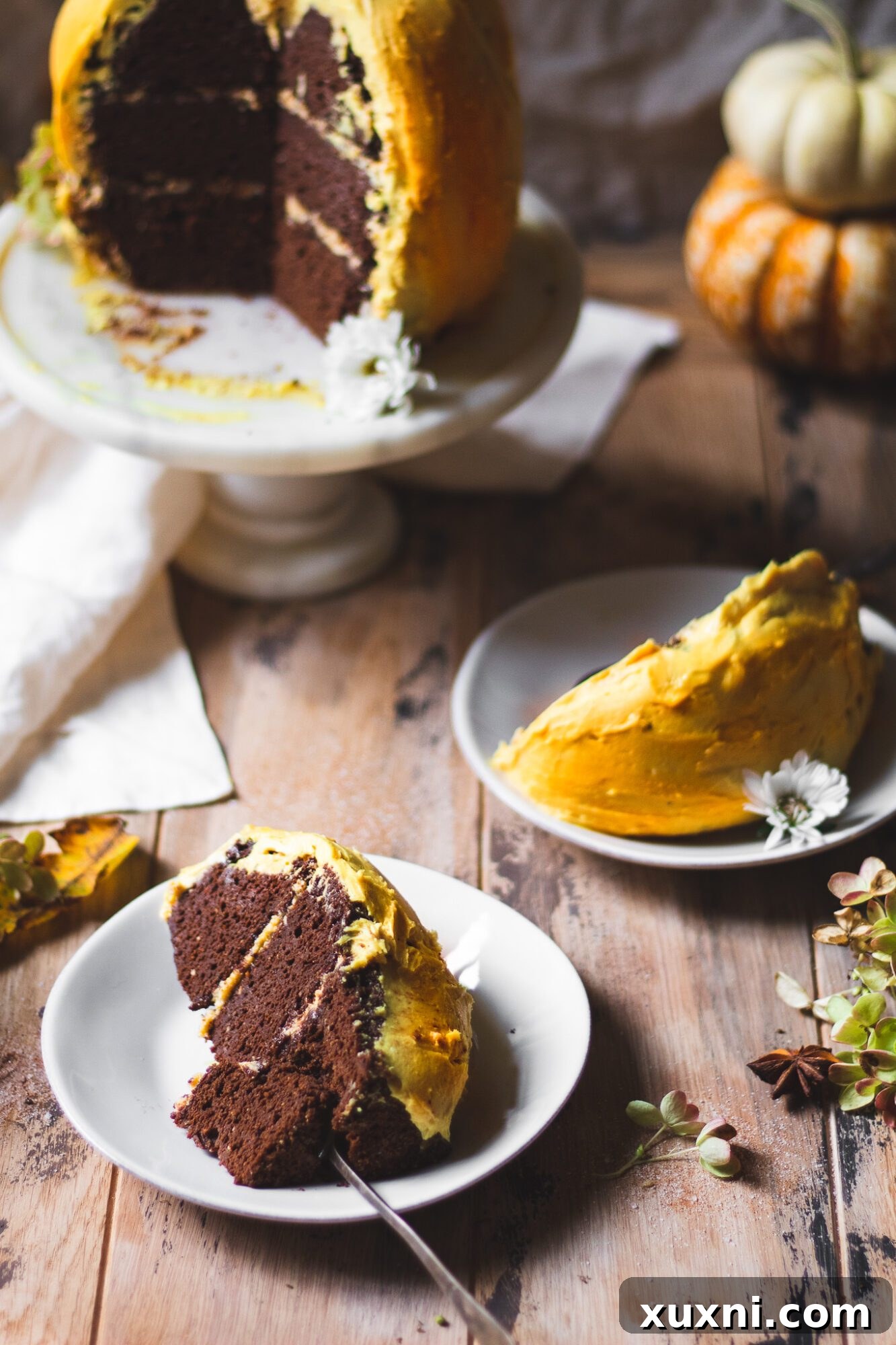 Delicious slices of the chocolate pumpkin cake, revealing the moist cake and creamy frosting, perfect for any Fall gathering.