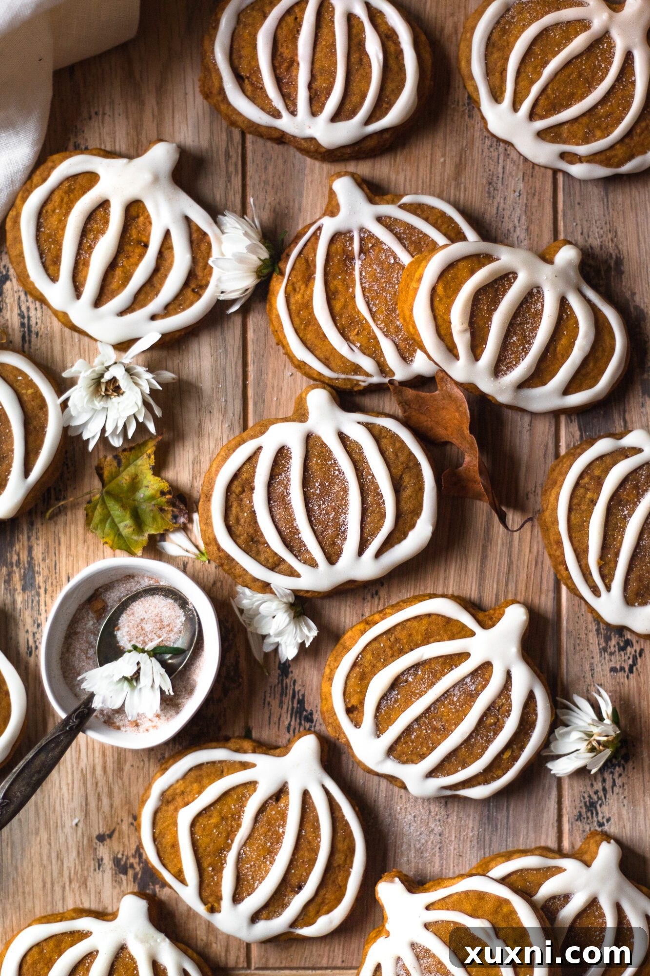 vegan pumpkin sugar cookies arranged on a wooden board