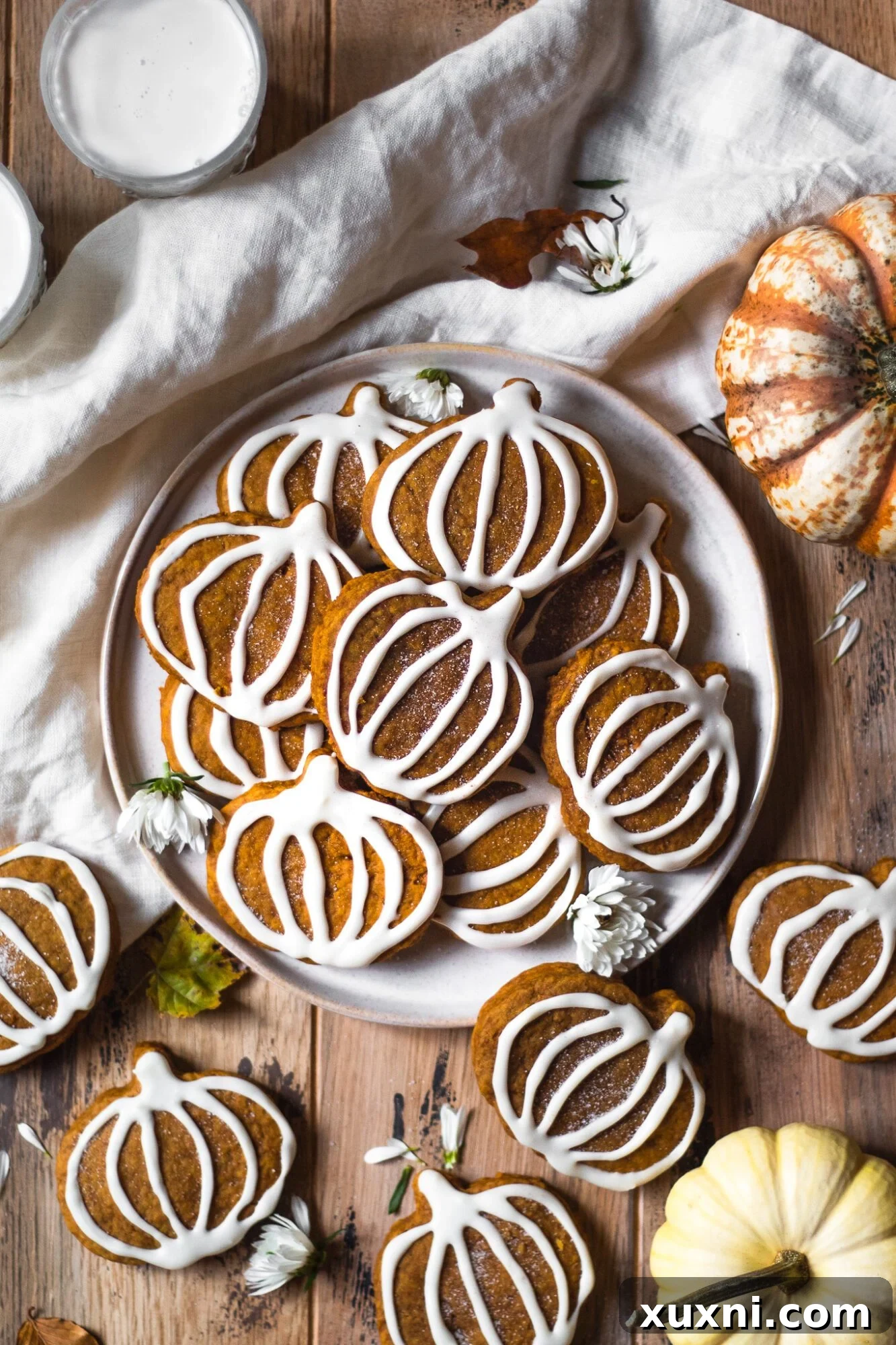 plate of decorated vegan pumpkin sugar cookies
