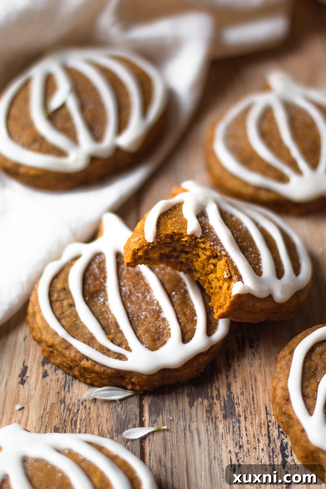 pumpkin sugar cookie with a corner bite