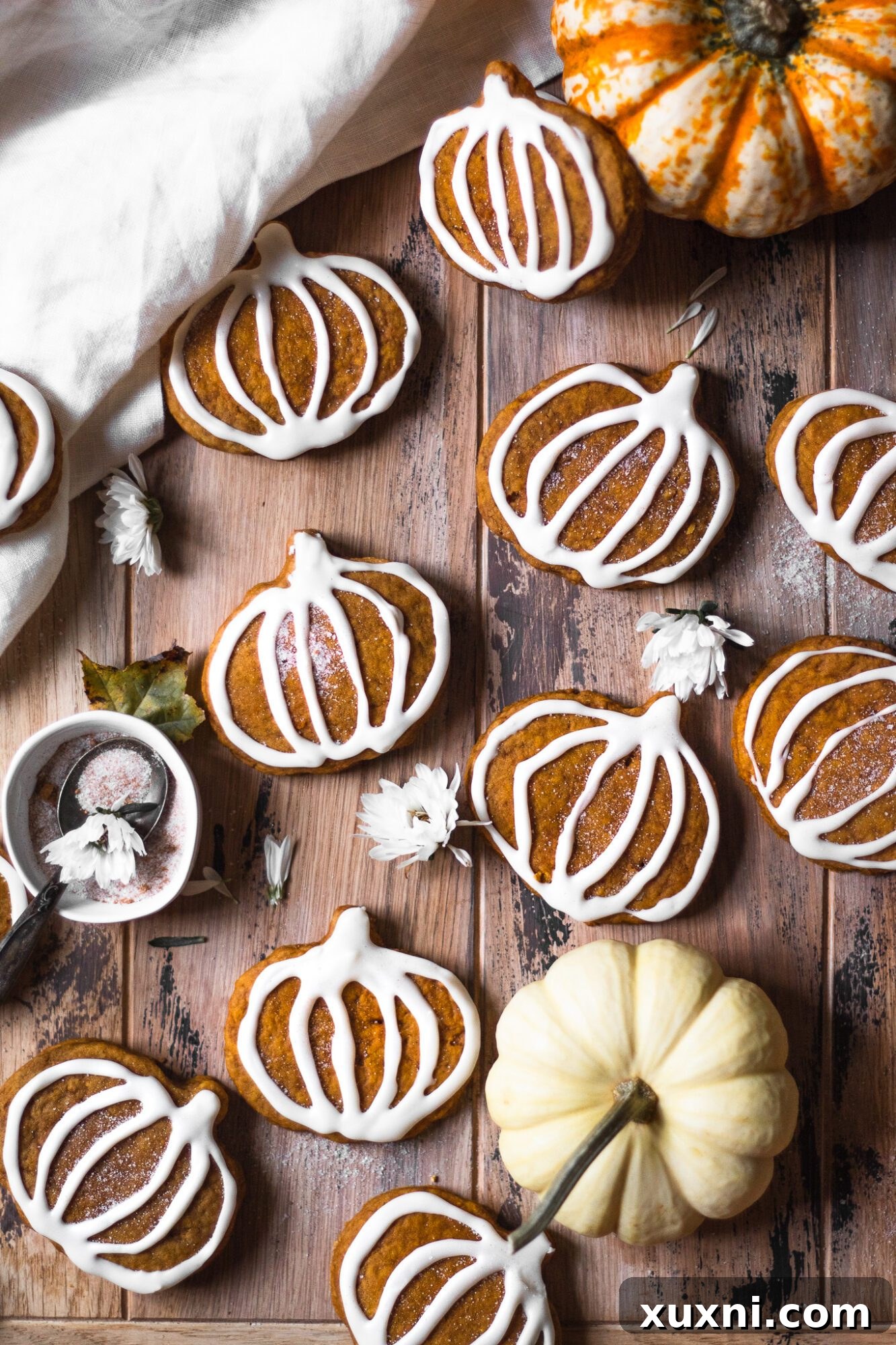 spread of various decorated pumpkin cookies