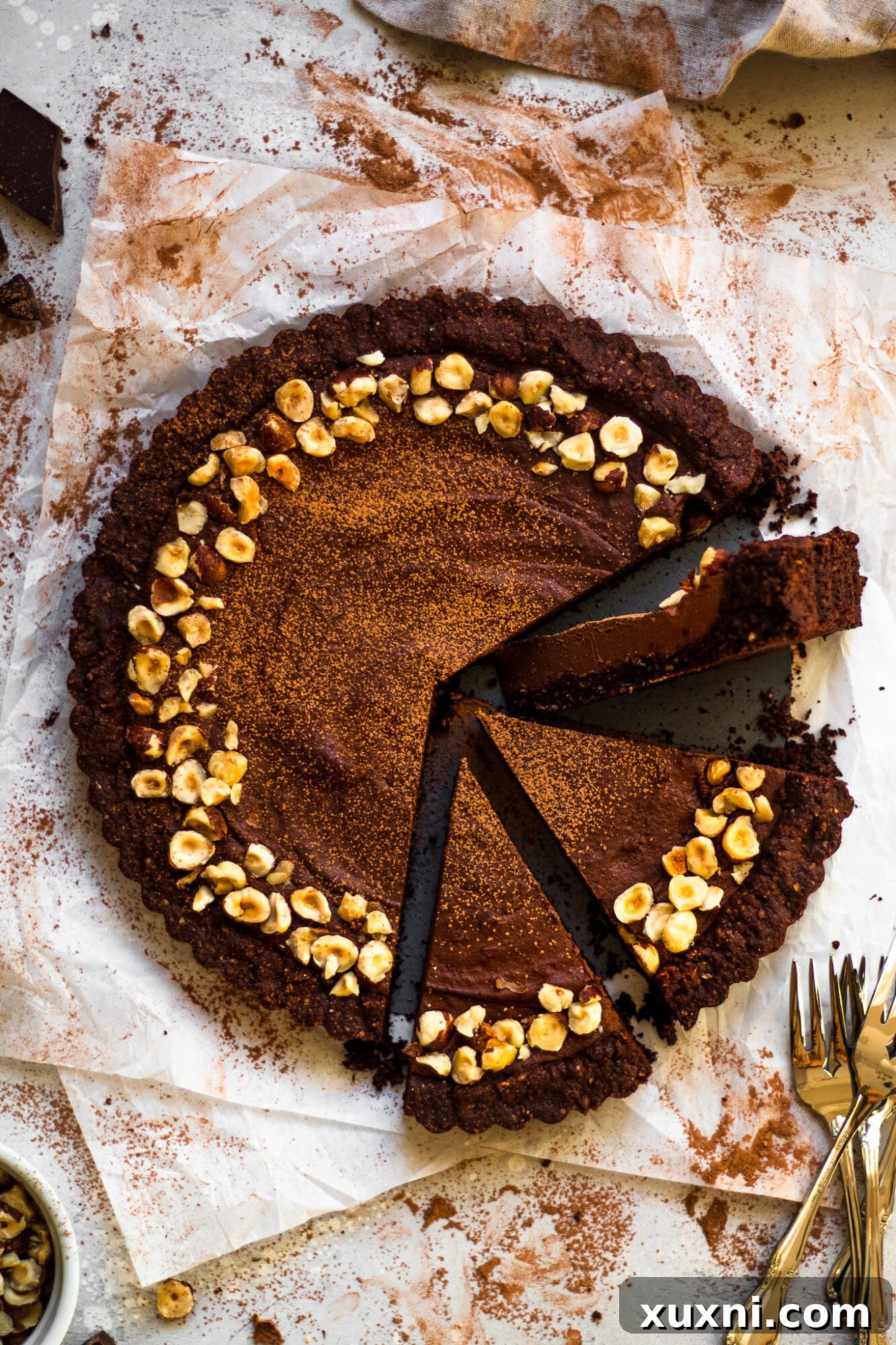 Multiple slices of vegan chocolate tart arranged on a white serving dish, demonstrating its inviting presentation