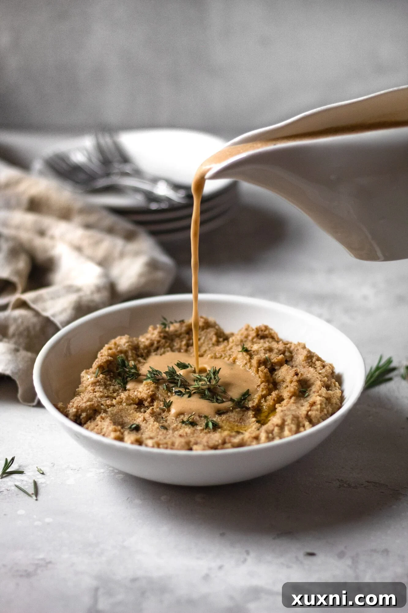 pouring gravy over mashed cauliflower