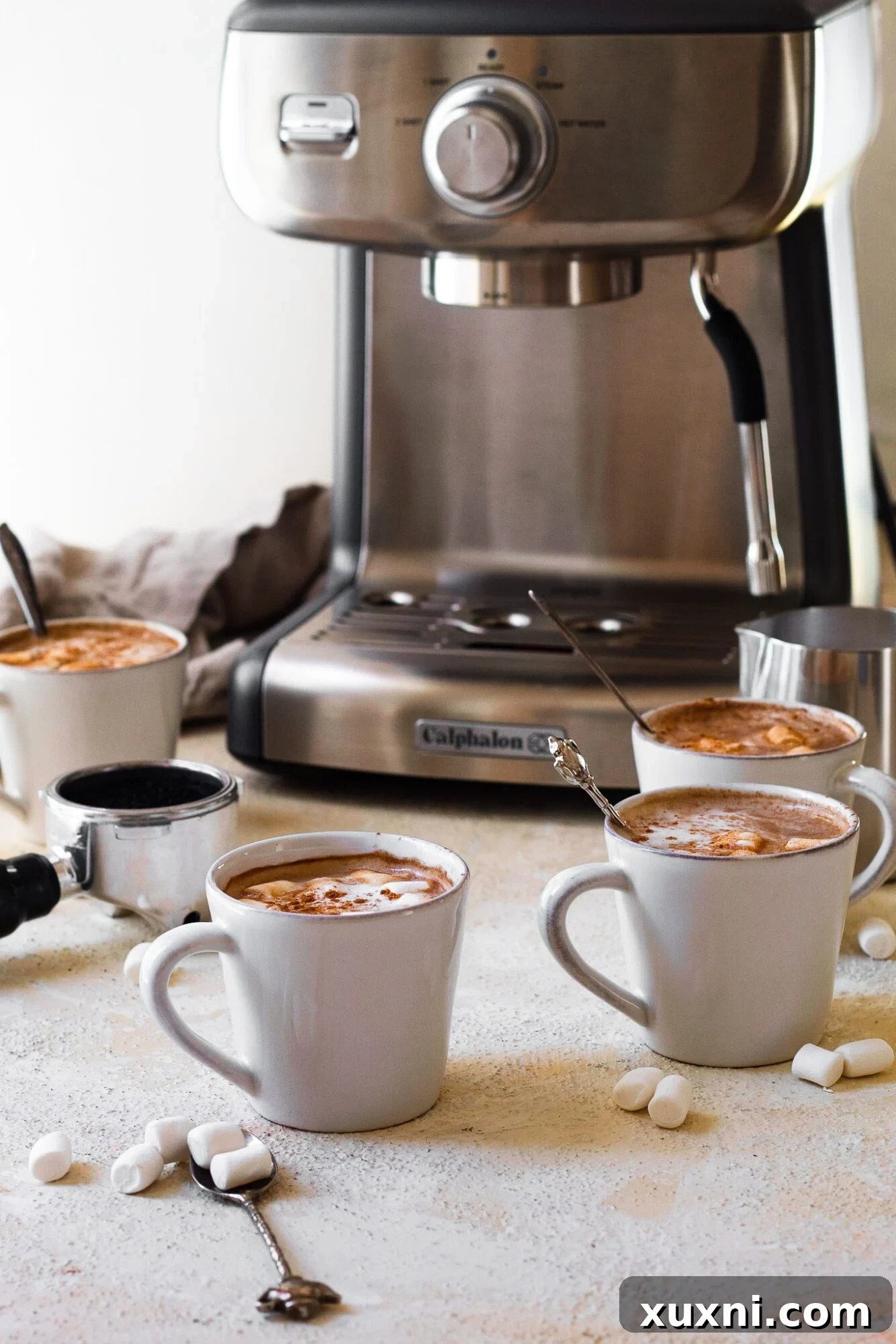 Multiple mugs of healthy mocha lattes next to the espresso machine