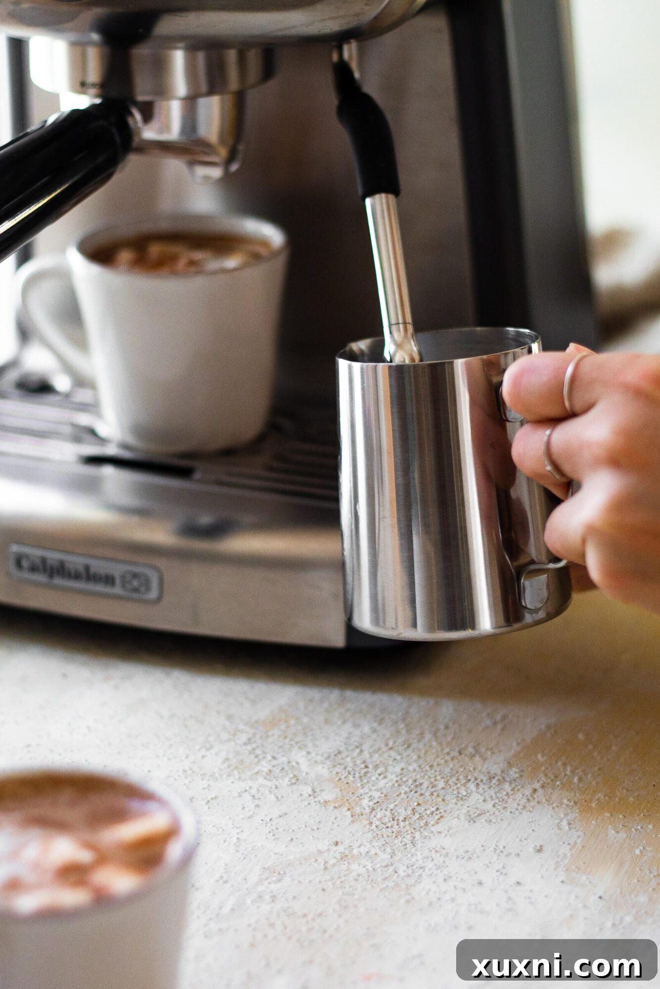 Hand steaming coconut milk in an espresso machine