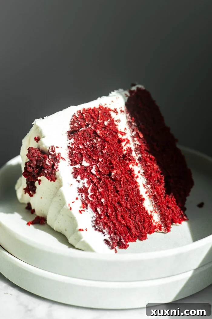 A close-up of the tender crumb of a red velvet cake, showing its moist texture.