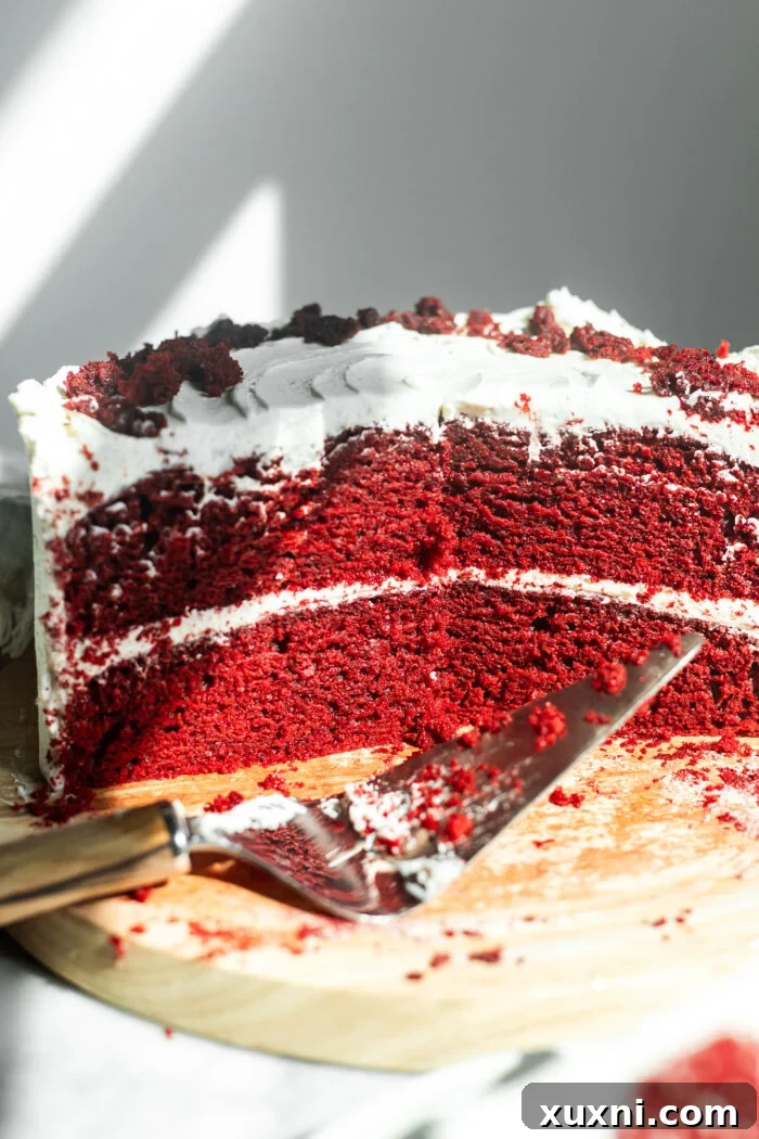Another perspective of the sliced vegan red velvet cake, emphasizing its appealing layers.