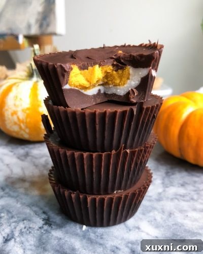 A top-down view of several Vegan Pumpkin Coconut Butter Cups in a muffin tin, ready to be chilled.