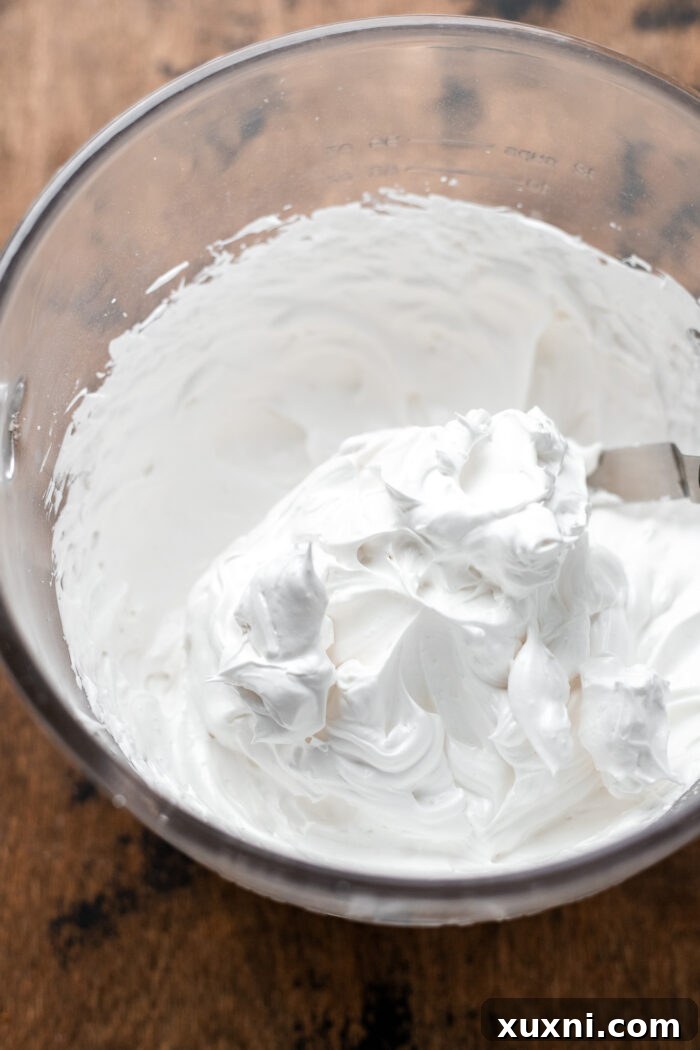 A bowl of fluffy vegan marshmallow meringue, perfectly whipped and ready to be spread.