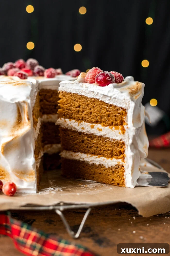 A perfectly sliced piece of vegan sweet potato spice cake revealing layers of moist cake and creamy frosting, ready to be enjoyed.