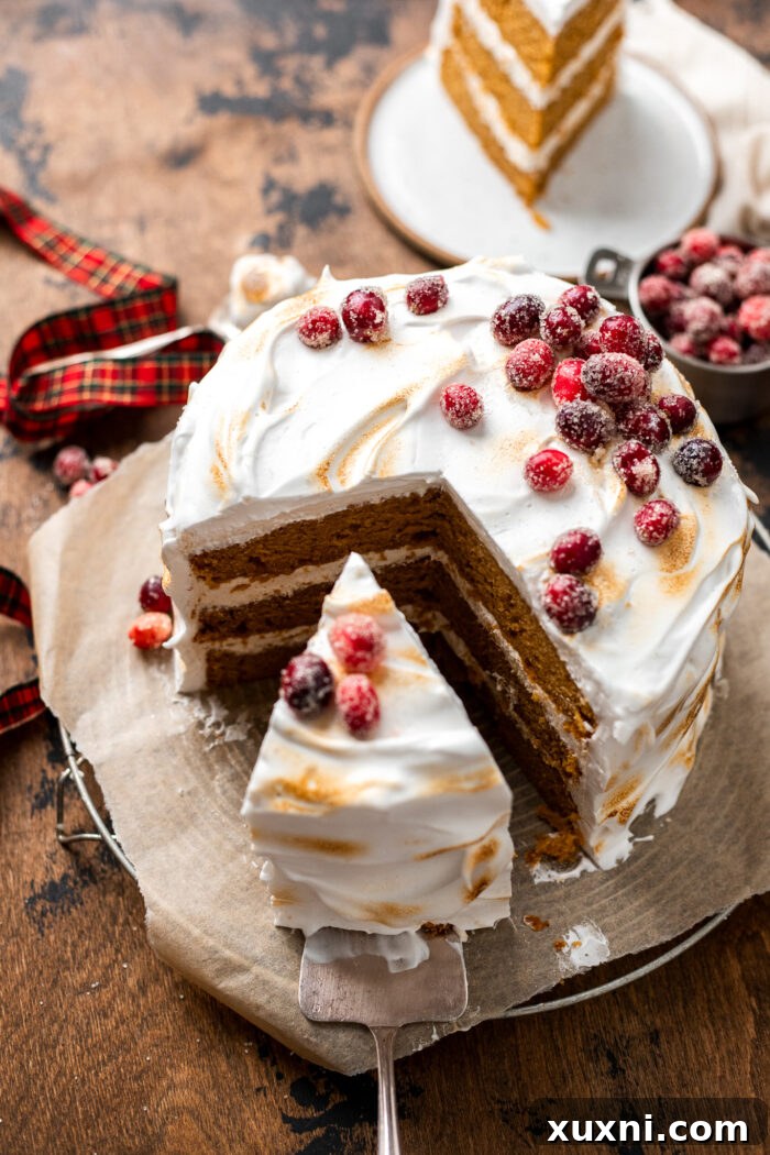 A delicious slice of vegan sweet potato spice cake adorned with creamy frosting, served elegantly on a cake board.