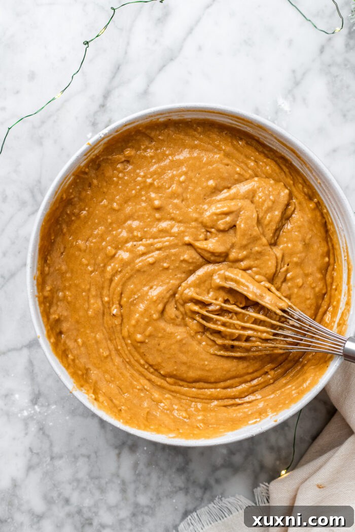 The fully mixed, smooth spice cake batter in a bowl, ready for baking.