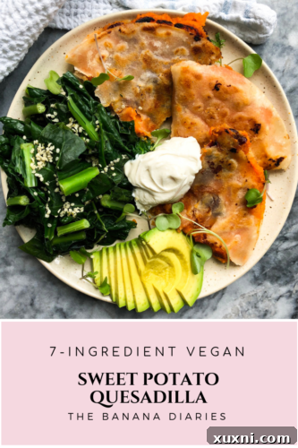 A serving of vegan sweet potato quesadilla with a side of guacamole and a fork.