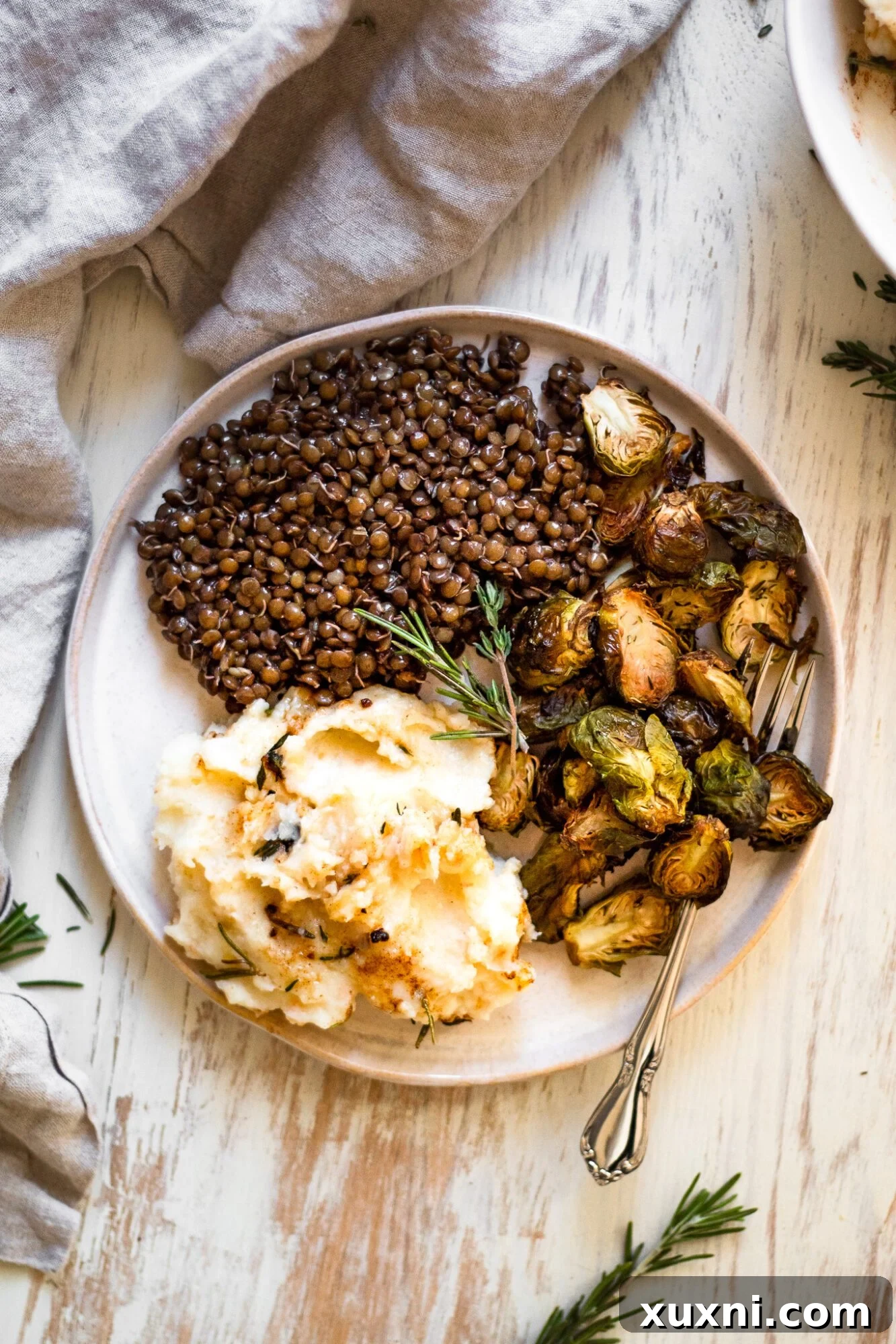 plated mashed potatoes with lentils and roasted brussels sprouts