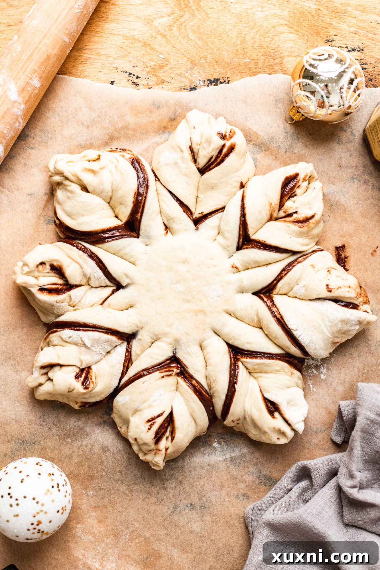 Instructions on how to twist and pinch star bread dough into its final shape