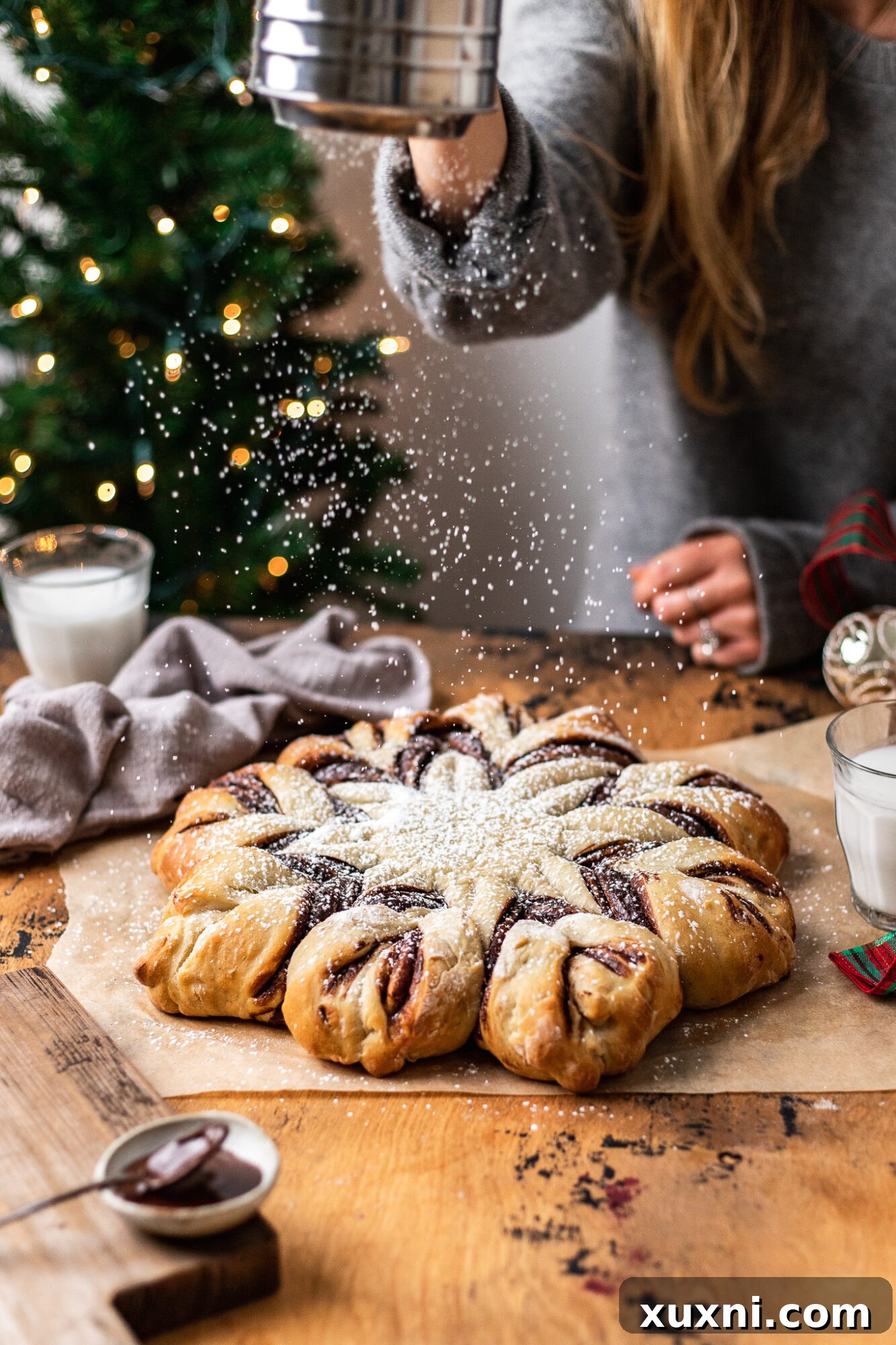 Close-up of a delicious vegan chocolate hazelnut star bread slice, showing the twisted layers