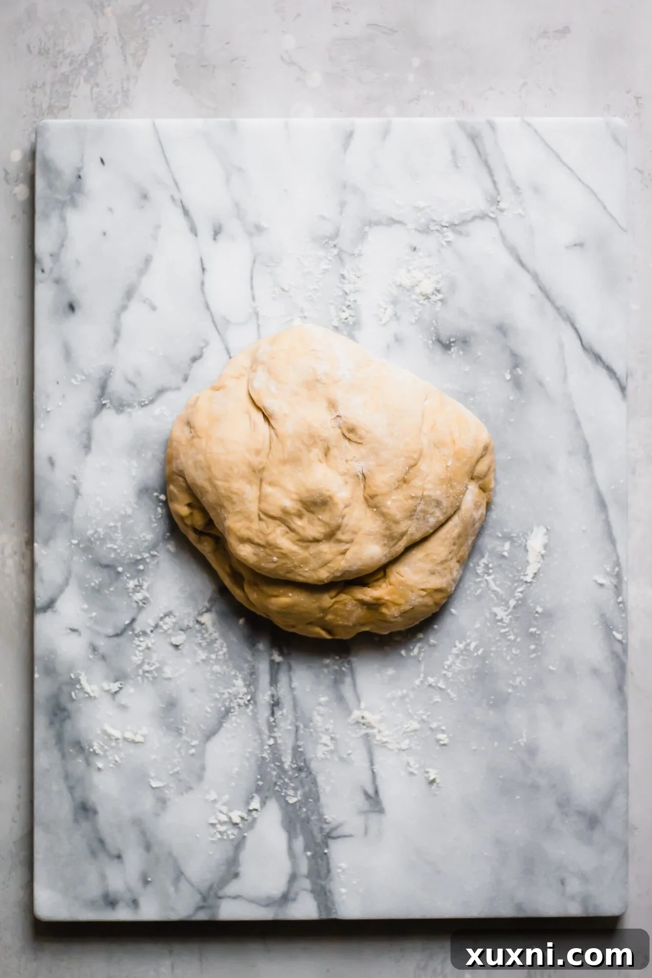 Dough resting on a marble slab, ready to be divided