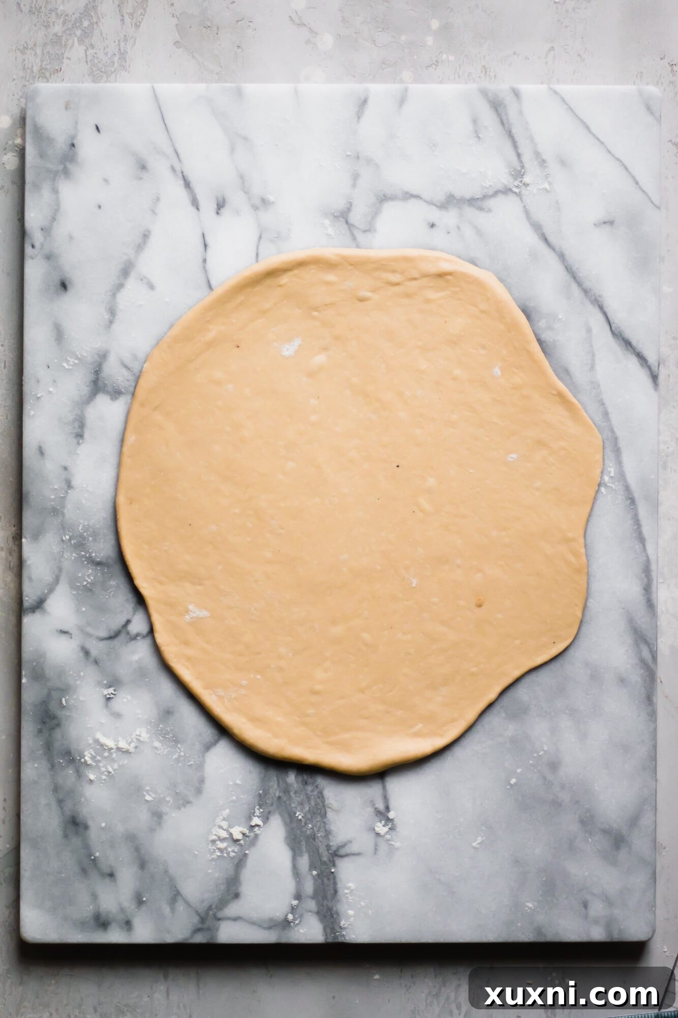 Perfectly rolled out circular dough, ready for layering