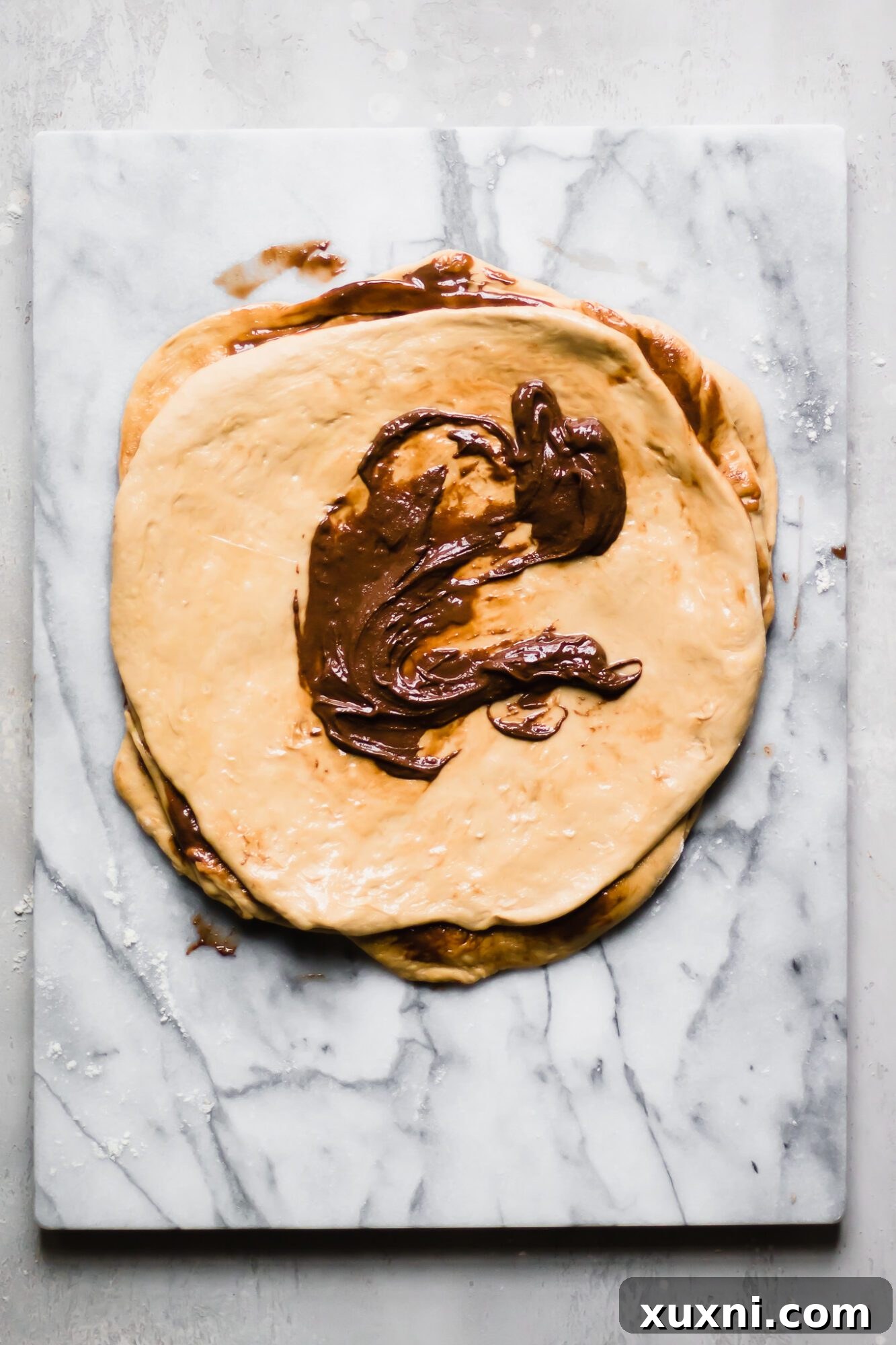 A section of dough spread with luscious vegan chocolate hazelnut spread