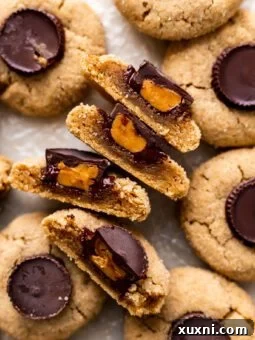 Soft Baked Peanut Butter Cup Cookies (Vegan + Gluten Free) sliced in half
