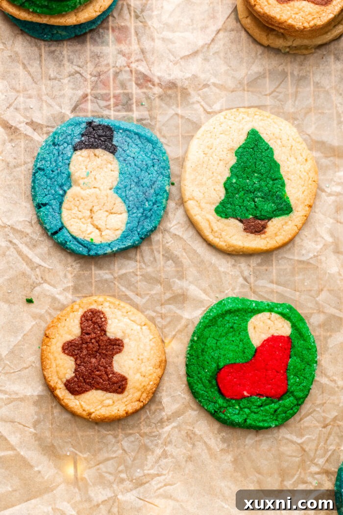 four holiday Pillsbury cookies on parchment paper