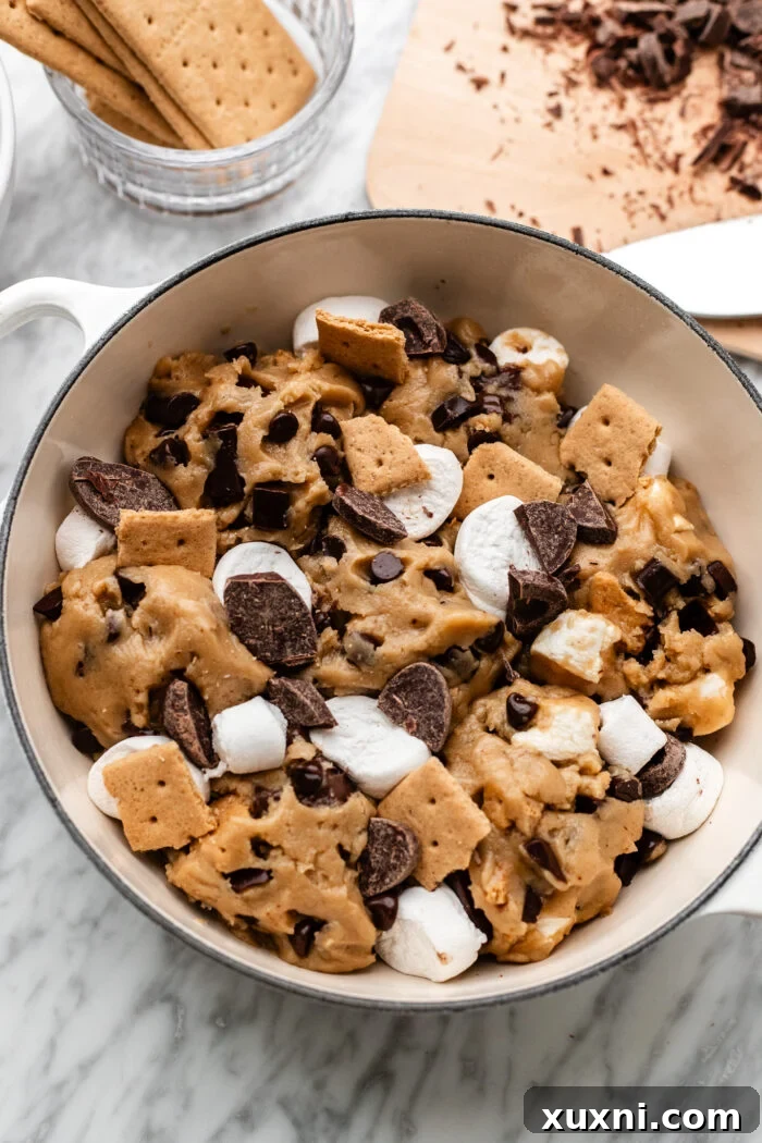 Assembled vegan s'mores scoopable cookies in a baking dish before baking.
