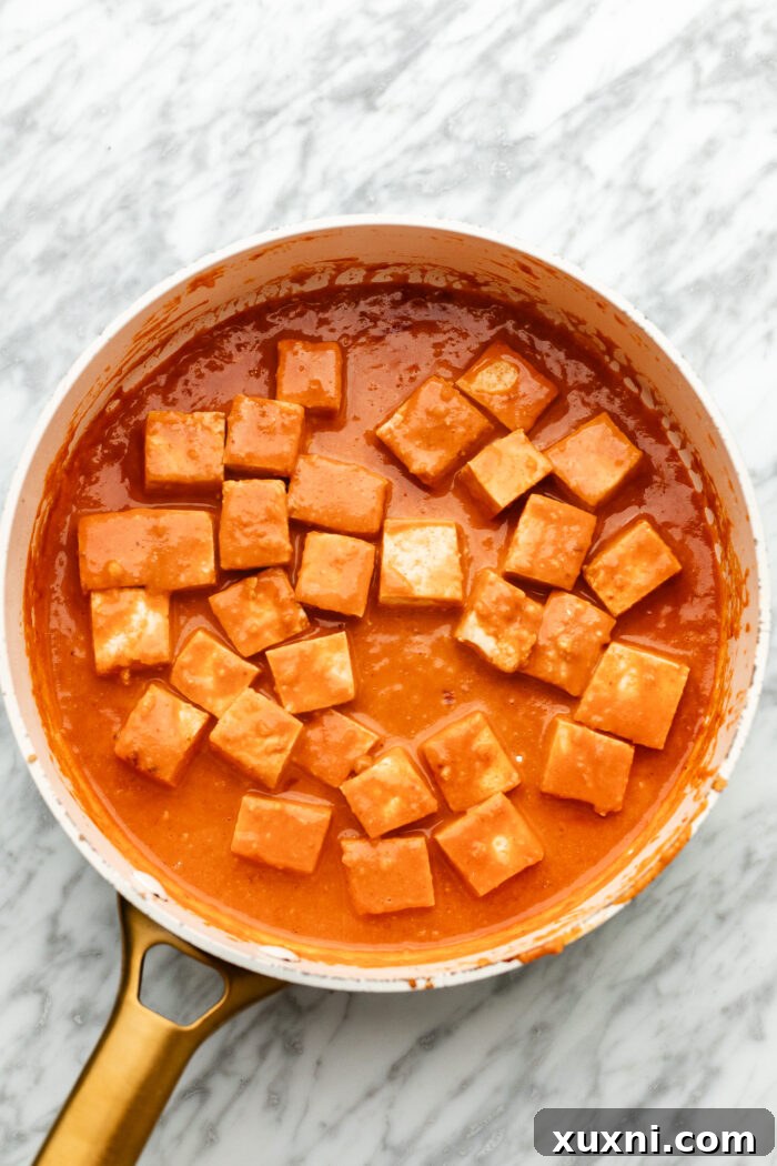 cooking the tofu in the sauce