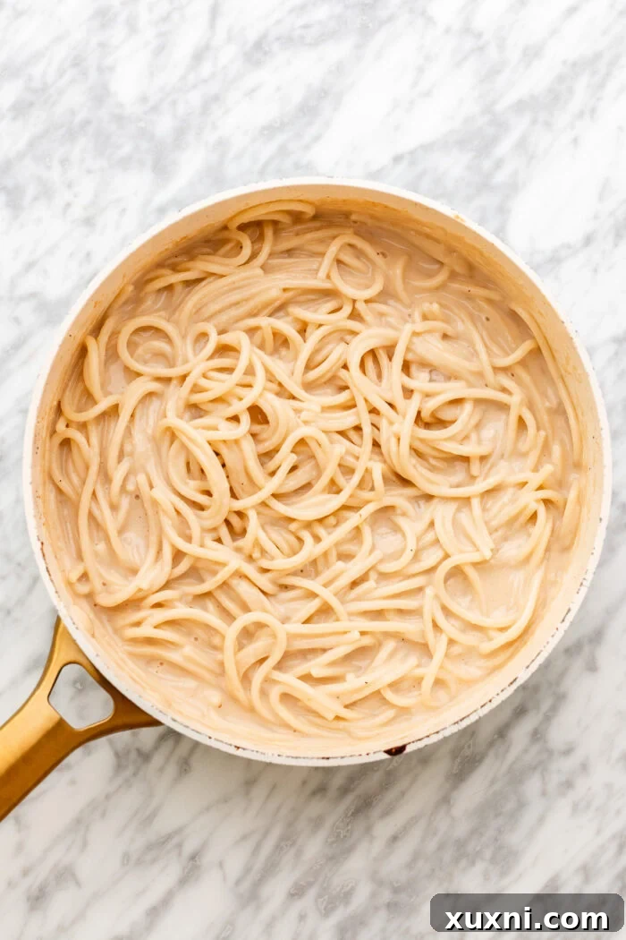 adding in the spaghetti