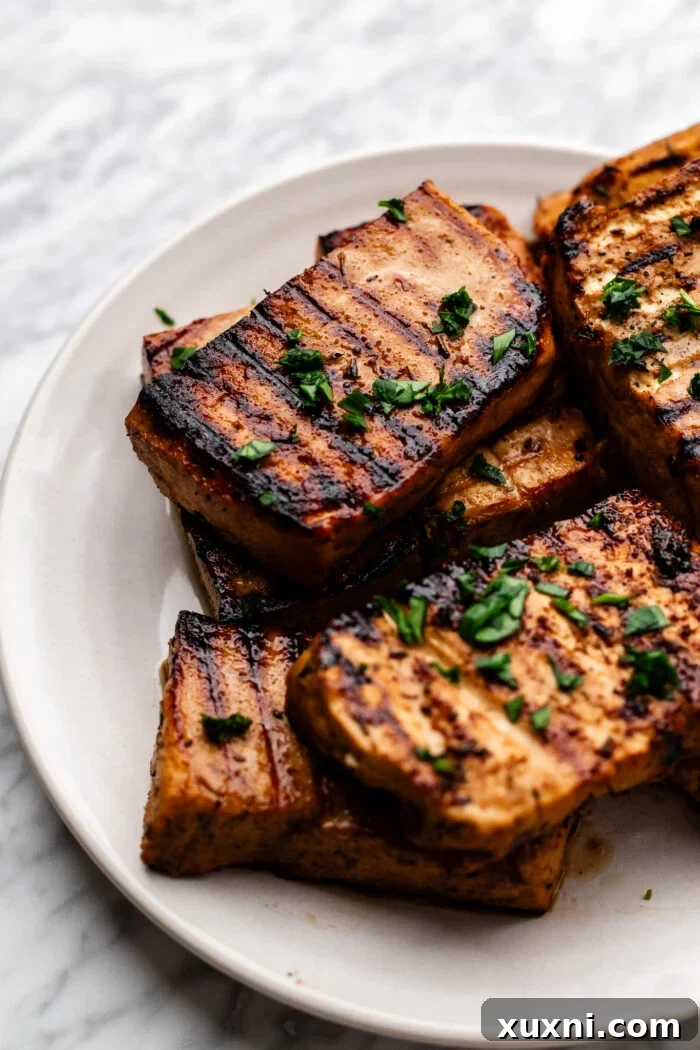 Juicy Grilled Balsamic Marinated Tofu Recipe 2 grilled tofu on a plate